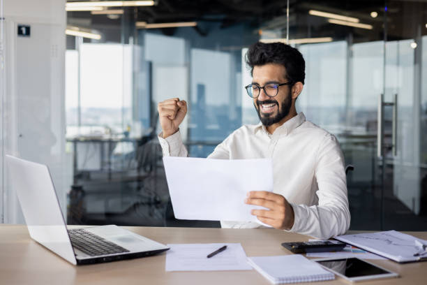 istock A white-collar worker on a desk with a laptop in an office building. 2029607169