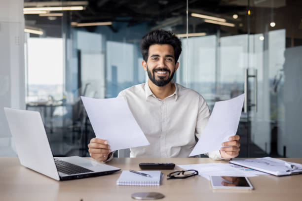 istock Confident indian businessman in office setup with laptop and documents 2029607175