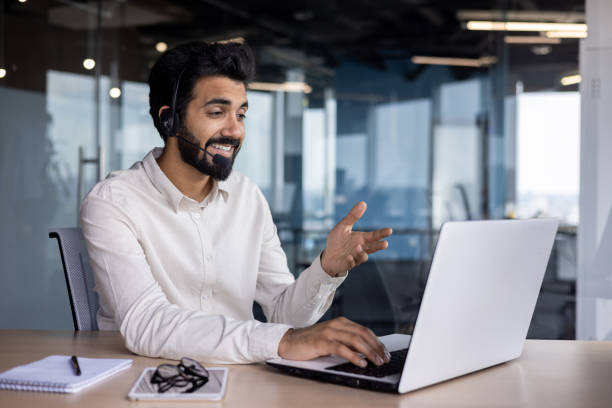 istock Indian businessman in office engaging in virtual communication with laptop 2029608230