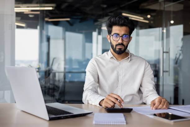 istock Focused indian businessman working on laptop in modern office space 2029608246