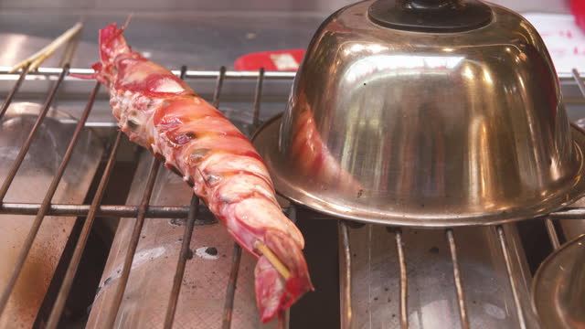 View of shrimp and crab grilled on a charcoal brazier