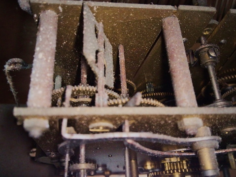 Photo of a dusty and somewhat rusty chime mechanism.