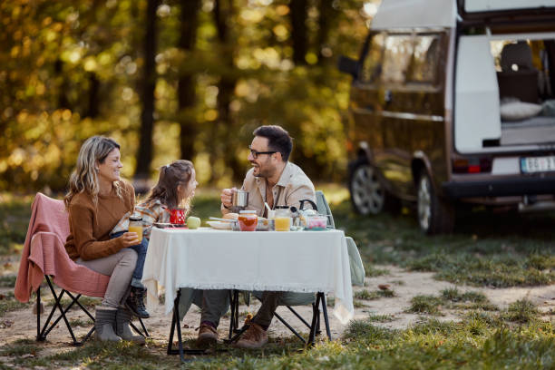 istock Happy family talking while relaxing on picnic at trailer park. 2029618782