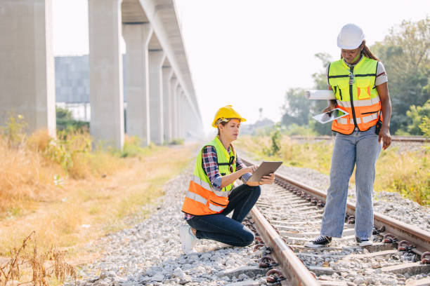 istock Engineer female railway tracks service team working on site survey check maintenance inspection train track for new construction and safety check 2029622412