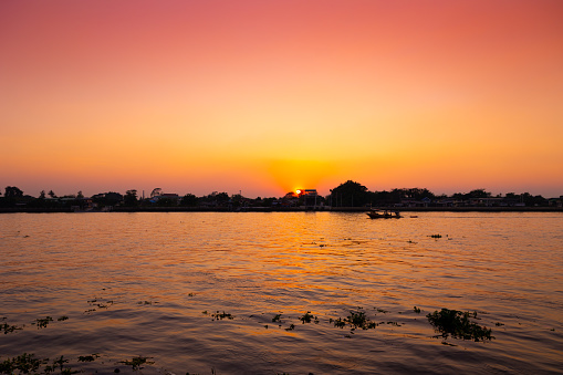 dusk dawn river view sunset orange sky. evening silhouette boat quiet calm chaophraya riverside landscape