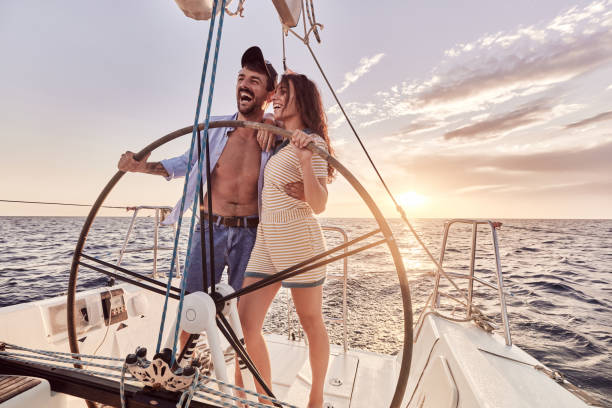 istock Cheerful couple having fun while driving a boat at sea. 2029632415