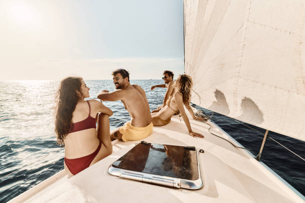 istock Happy couples talking while relaxing on a boat in summer day. 2029633956