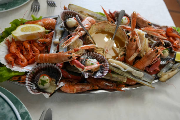 istock A seafood platter, abundant with fresh prawns, scallops, spider crab,and garnished with herbs and lemon, presents a feast for the senses. Galicia Spain 2029668675