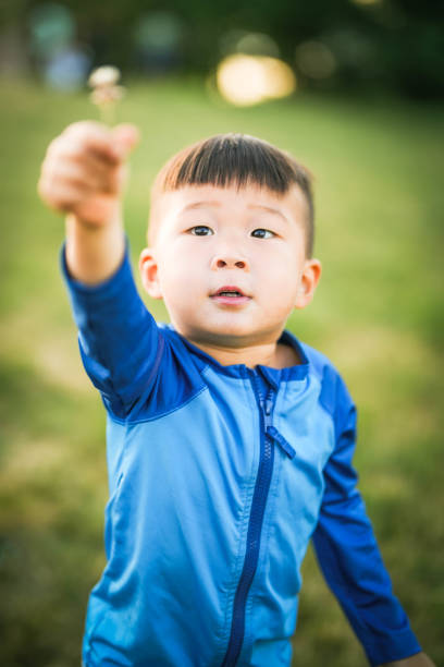 Boy with Dandelion in the Park