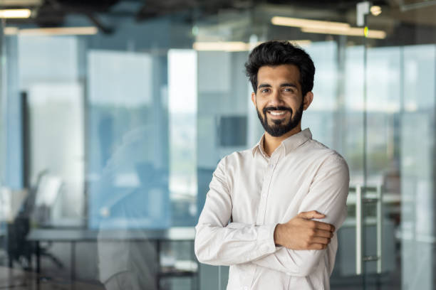 istock Confident indian businessman smiling in modern office setting, corporate professional portrait 2029689077