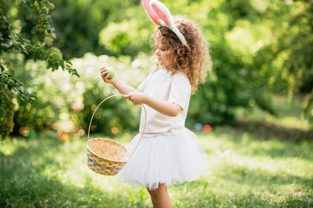 istock Baby with basket full of colorful eggs. Easter egg hunt. 2029707983