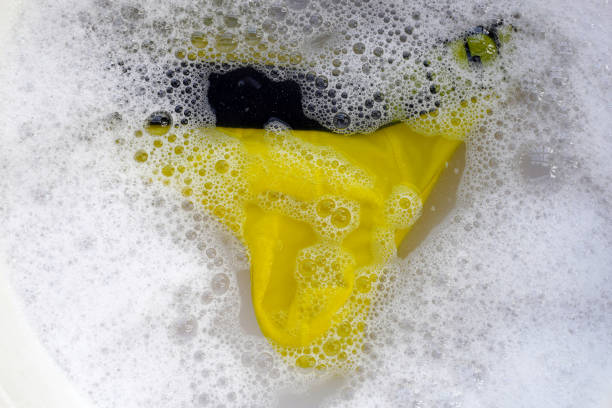 Men underwear soaked in water dissolved detergent with white foam bubble. Laundry concept