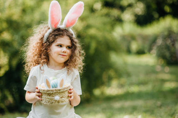 istock Baby with basket full of colorful eggs. Easter egg hunt. 2029712785