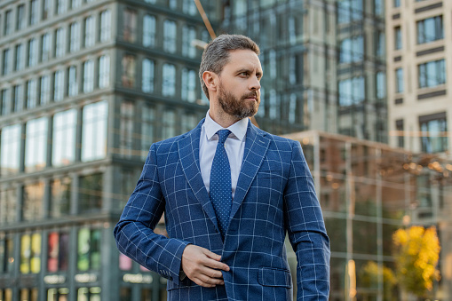adult business professional outdoor. business professional on urban background. business professional wearing jacket in the street. photo of business professional with tie.