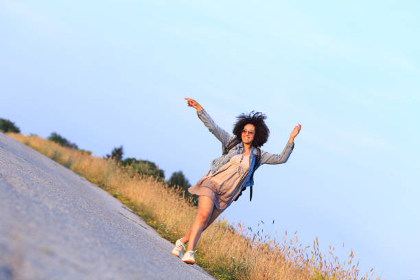 African female backpacker, hiking in countryside