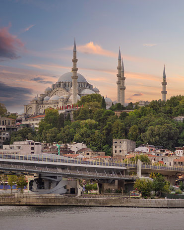 Sunset shot of Golden Horn Metro Bridge, or Halic Bridge, overlapping Suleymaniye Mosque, Istanbul, Turkey