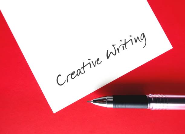 istock On red background - pen writing on notebook CREATIVE WRITING, means writing with imaginative approach to subject matter - displays creative imagination or invention 2029765517