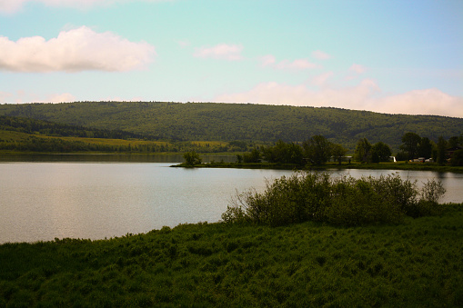 A tranquil Newville Lake surrounded by lush greenery