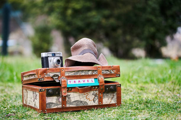 A vintage suitcase, a camera and a hat. Travel destinations concept.