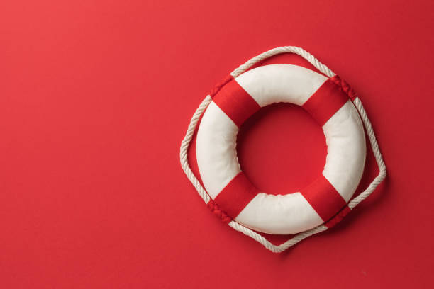 istock Lifebuoy on a red background with copy space on the left side of the frame, top view 2029794773