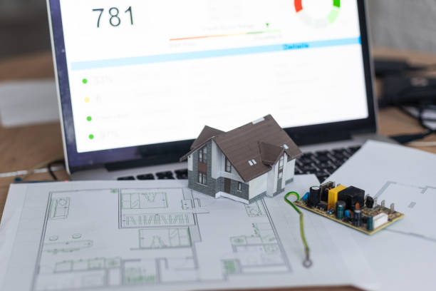 istock Model house in front of computer with financing plan - mortgaging or home financing concept 2029801577