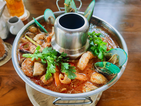 Close-up shot of Spicy Seafood hot pot Thai Tom Yum Soup