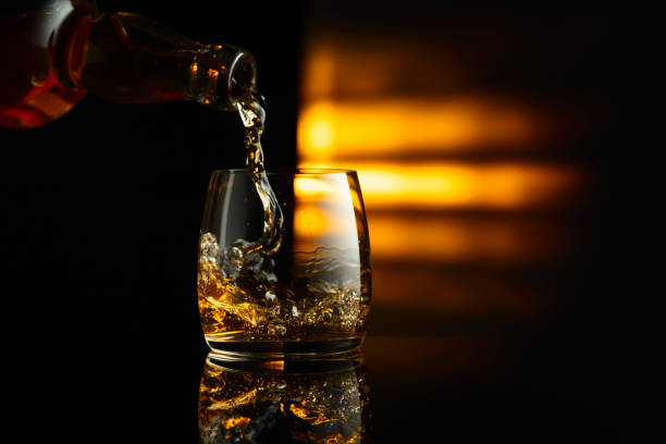istock Pouring whiskey from a bottle into a glass. 2029816884