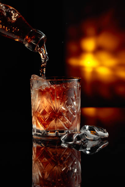 istock Pouring whiskey into a glass with ice. 2029816889