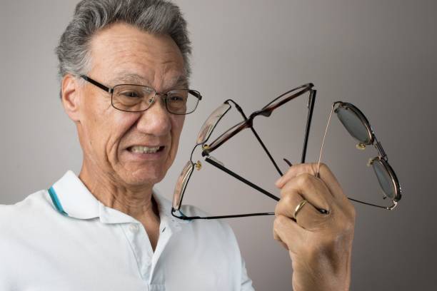 istock Elderly man holding up a bunch of eyeglasses 2029845016