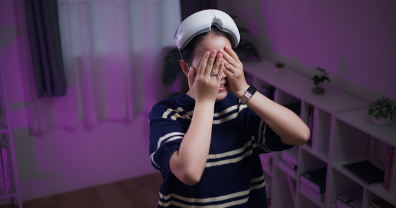 High angle view, Cheerful young woman enjoy with glasses of virtual reality, digital world and 3D connection, gaming and future technology in living room at home.VR technology, Innovative