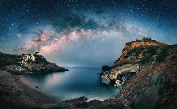 Amazing night sky with Milky Way over scenic coast
