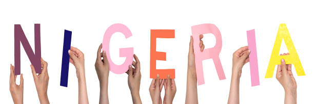 istock closeup hands people forming Nigeria text with colorful letters. 2029896599