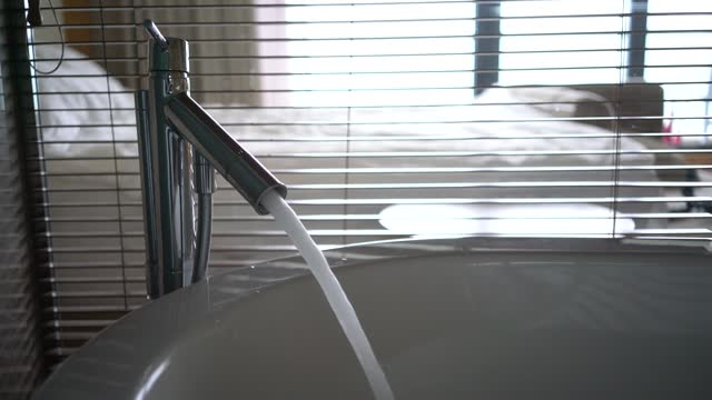Close-up of water running into the bathtub