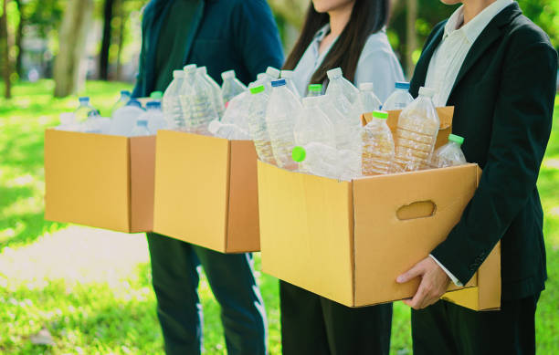 istock team people are holding boxes with plastic bottle garbage for recycling concept reuse. Copy space for use sign or text 2029907264