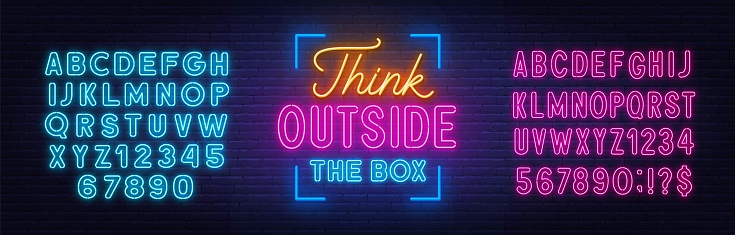 Think outside the box - neon lettering on brick wall background.  Pink and blue neon alphabets.