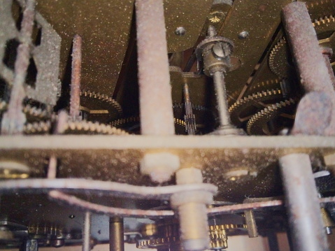 Photo of a dusty and somewhat rusty chime mechanism.