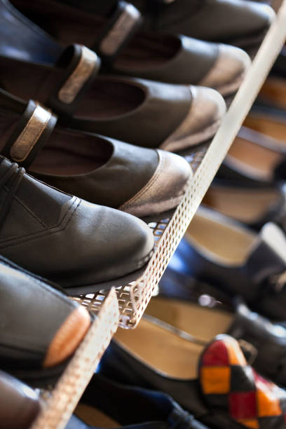 Various pair of shoes on a stall in a fashion store