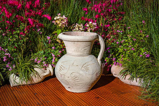 Clay Amphora Ceramic Terracotta Pots at flowers decorations background