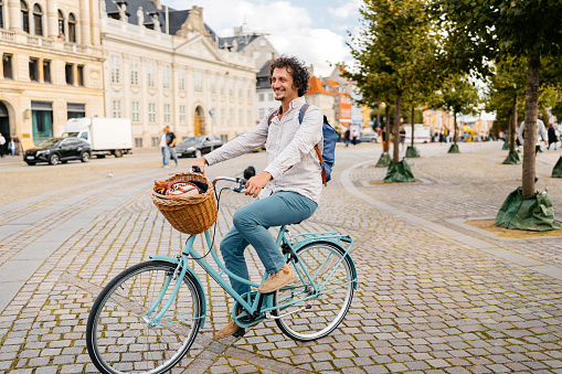 Young man riding a bike on the street in Copenhagen in Denmark.