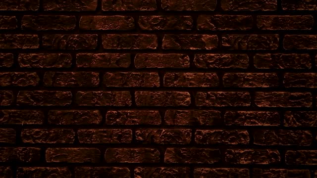 Close-up of a designer wall in the form of an ancient brick, dimly lit wall.