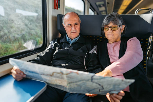 istock Senior Couple Reading A Map While Riding In A Train In Switzerland 2029994427