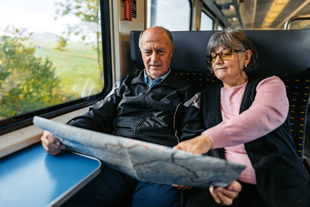 istock Senior Couple Reading A Map While Riding In A Train In Switzerland 2029995458