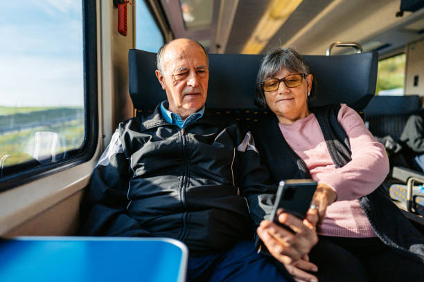 istock Senior Couple Looking Up Directions On A Smart Phone While Riding In A Train In Switzerland 2029996521