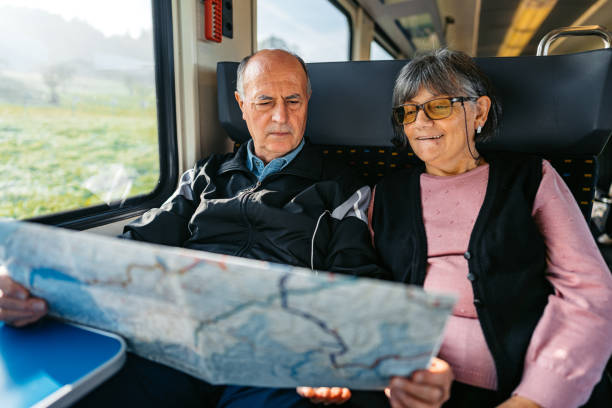 istock Senior Couple Reading A Map While Riding In A Train In Switzerland 2029997568