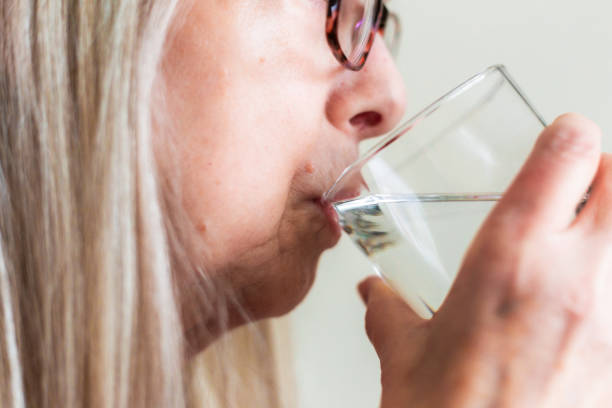 istock Profile view of senior woman drinking water 2029997575