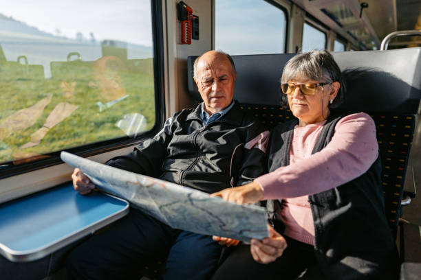 istock Senior Couple Reading A Map While Riding In A Train In Switzerland 2029998088