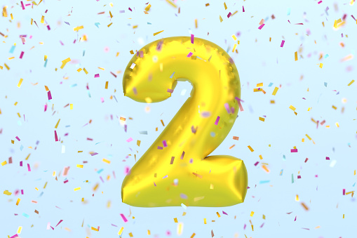 Golden Number 2 And Confetti On Blue Background