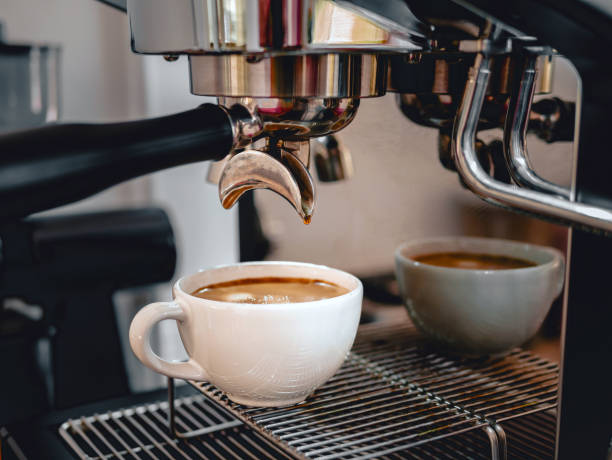 istock Coffee extraction from the coffee machine with a portafilter pouring coffee into a cup,Espresso poruing from coffee machine at coffee shop 2030002329