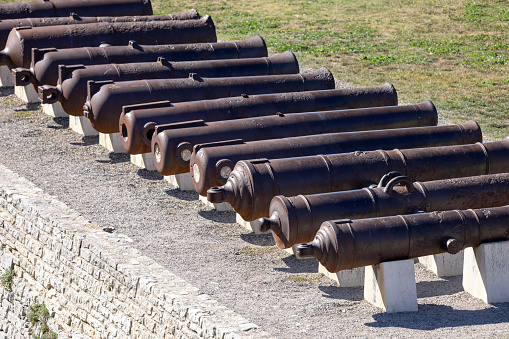 Pula, Croatia, Istria - September 29, 2023: Historic cannons in front of 17th century Castle (Venetian Fortress), defensive fortress built by the Venetians