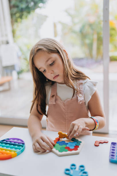 Girl with autism playing pop it
